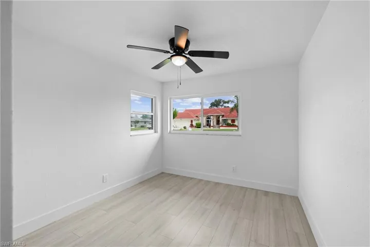 Unfurnished room with ceiling fan and light hardwood / wood-style flooring