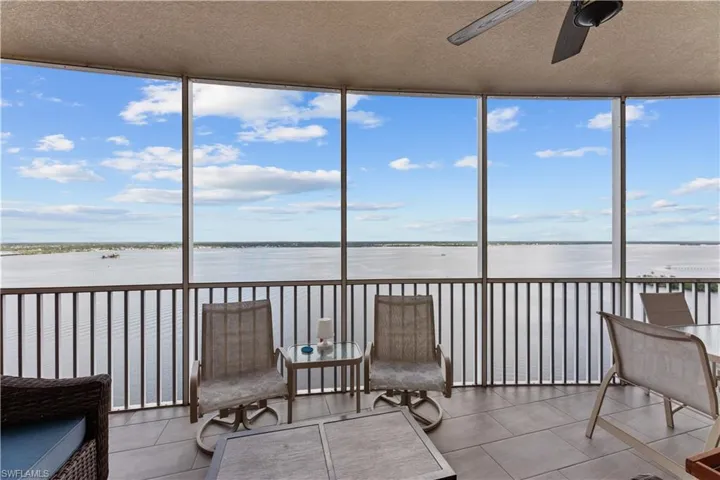 Sunroom featuring a water view and ceiling fan