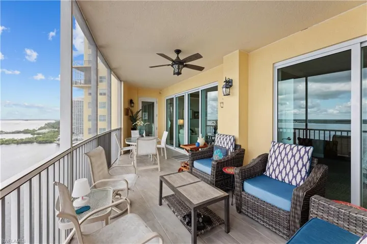 Sunroom / solarium featuring a water view and ceiling fan