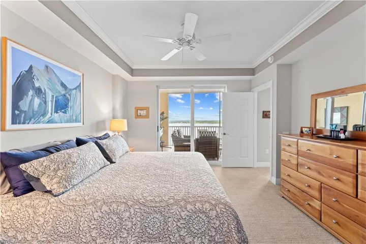 Bedroom with crown molding, access to outside, light colored carpet, and ceiling fan