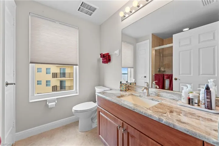 Bathroom with tile patterned flooring, toilet, and vanity