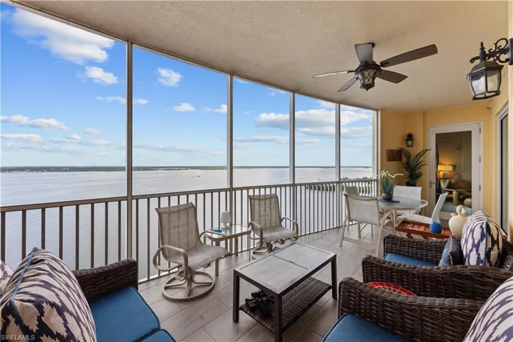 Sunroom featuring a water view and ceiling fan