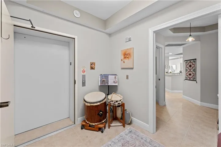 Bathroom featuring tile patterned flooring and a raised ceiling