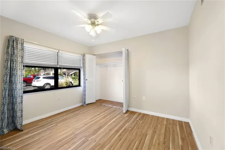 Unfurnished bedroom with light wood-type flooring, a closet, and ceiling fan