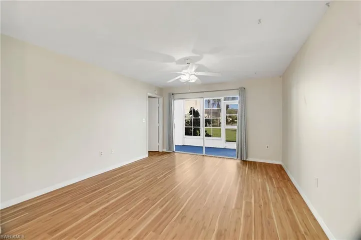 Empty room featuring light wood-style flooring and ceiling fan