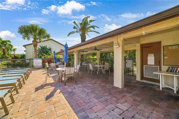 View of patio with outdoor dining space and a ceiling fan