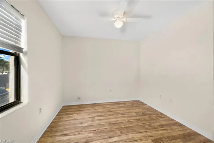 Spare room with light wood-style floors and a ceiling fan