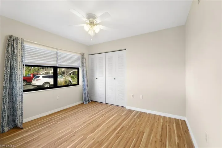 Unfurnished bedroom featuring light wood-type flooring, a closet, and ceiling fan