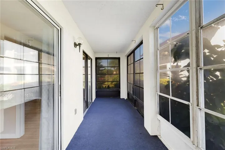 Unfurnished sunroom with carpet floors