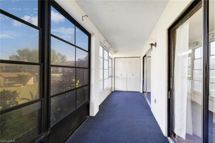 Unfurnished sunroom featuring carpet floors