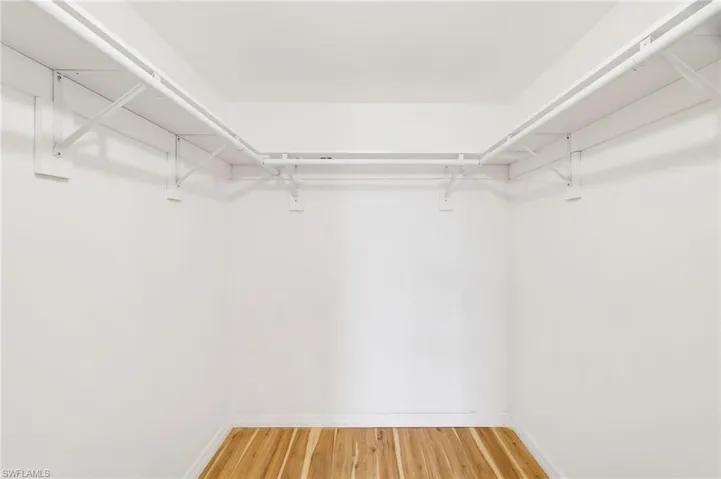 Spacious closet with light wood finished floors