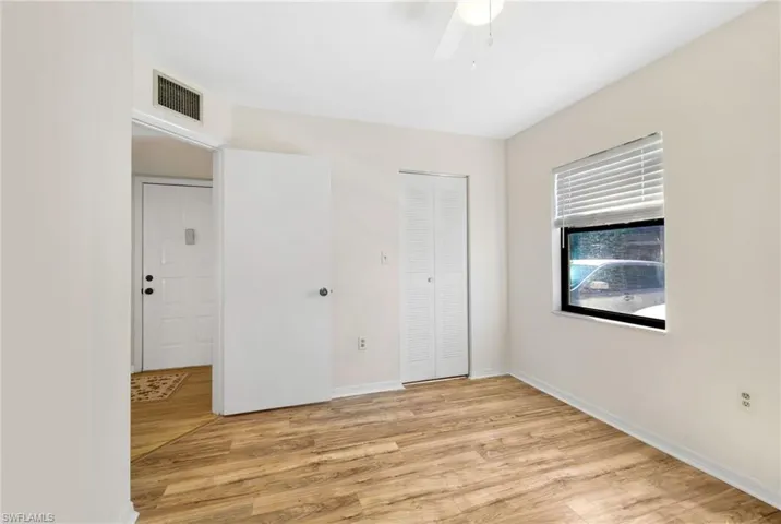 Unfurnished bedroom featuring light wood-style flooring, a closet, and a ceiling fan