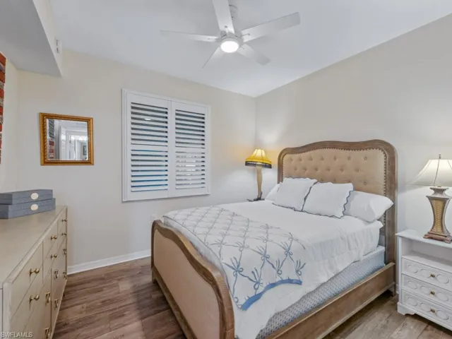 Bedroom with a ceiling fan, baseboards, and wood finished floors