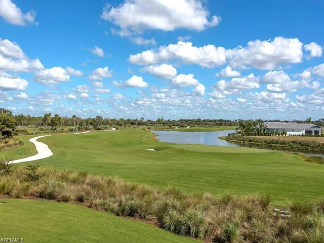 Surrounding community featuring a yard, a water view, and golf course view