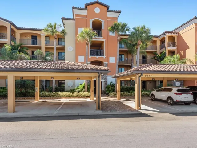 View of building exterior with covered parking