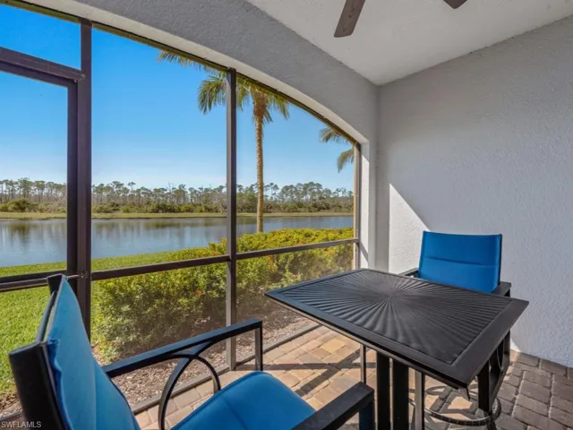 Sunroom / solarium featuring a water view, plenty of natural light, and ceiling fan