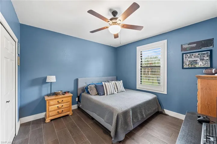 Bedroom with ceiling fan and a closet
