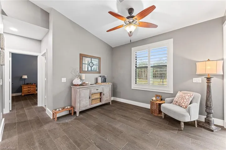 Living area featuring vaulted ceiling and ceiling fan