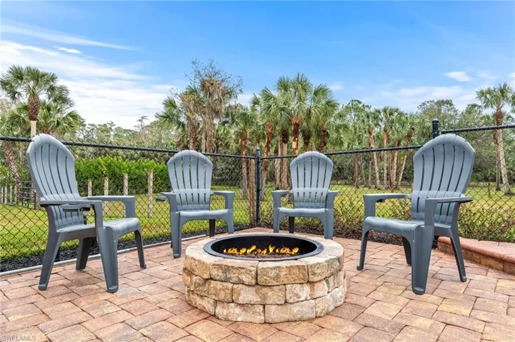 View of patio with an outdoor fire pit