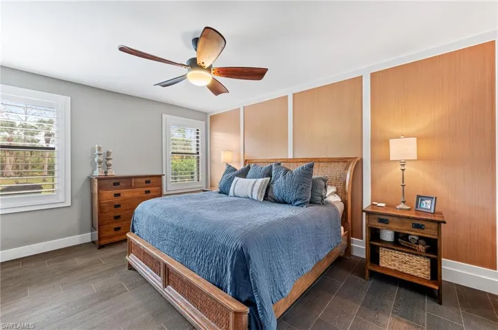 Bedroom with multiple windows and ceiling fan