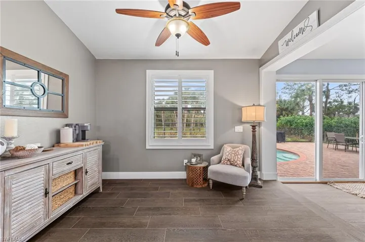 Living area with lofted ceiling and ceiling fan