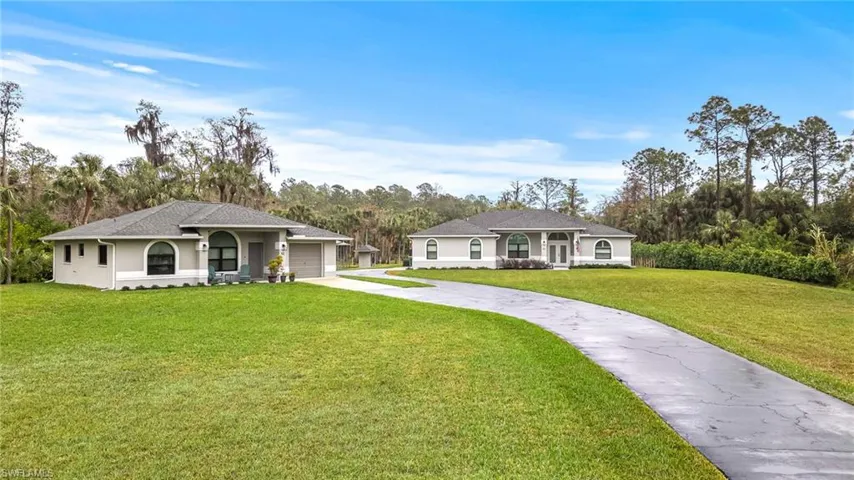Ranch-style home with a porch, a garage, and a front yard