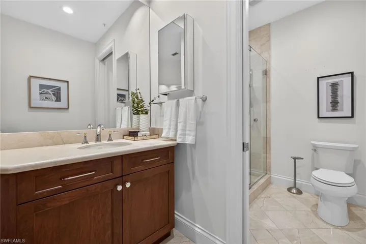 Full bath featuring a stall shower, vanity, recessed lighting, and light tile patterned floors
