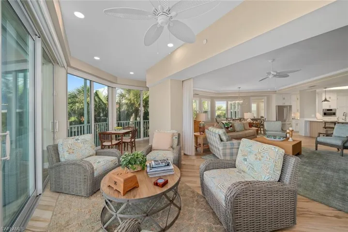 Living room featuring light hardwood / wood-style flooring, ceiling fan, and crown molding