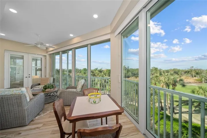 Sunroom / solarium featuring ceiling fan and french doors