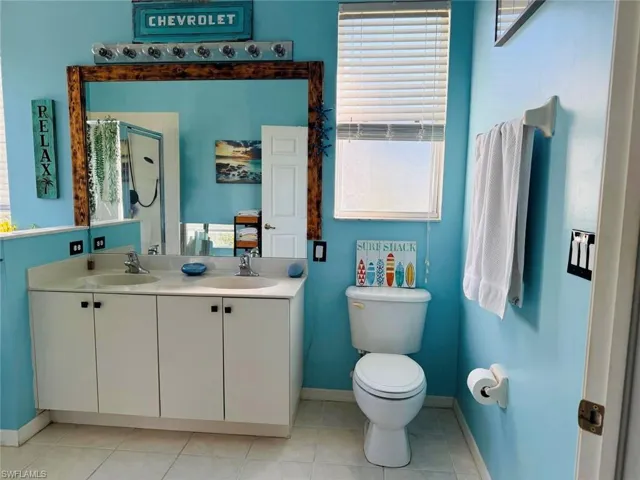 Full bath with light tile patterned floors, plenty of natural light, and a stall shower