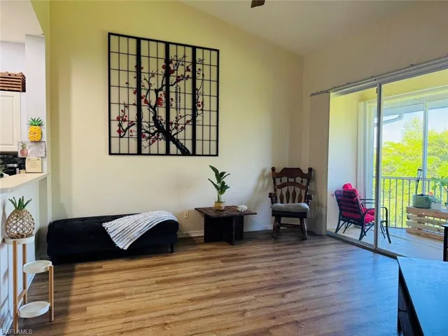 Sitting room with wood finished floors and baseboards
