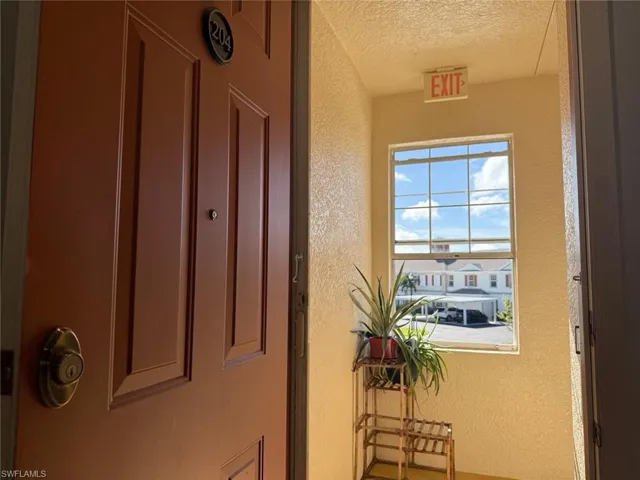 Hallway with a textured wall and a textured ceiling
