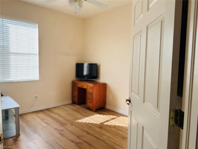Unfurnished office with wood finished floors and ceiling fan