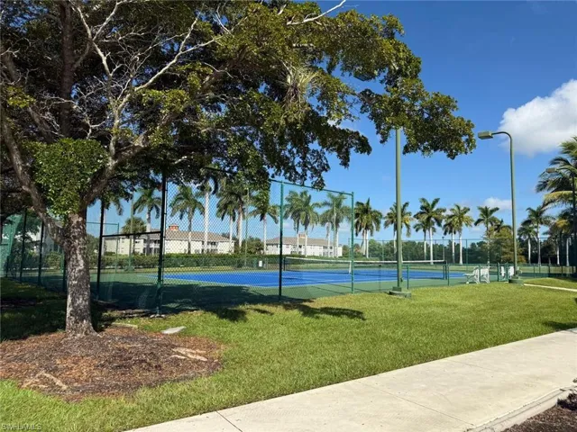 View of sport court featuring a tennis court