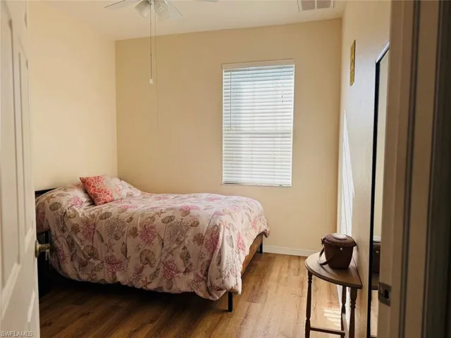Bedroom with wood finished floors and ceiling fan
