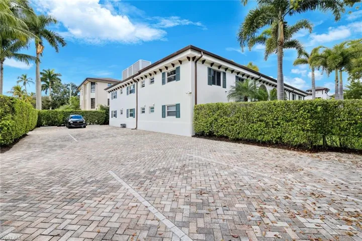 Brick-paver drive with easy access and a quiet, well-kept exterior setting.