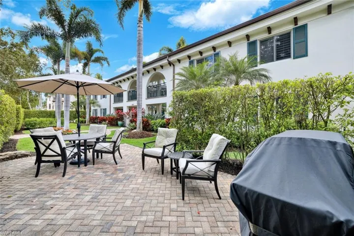 Inviting outdoor seating area surrounded by greenery — perfect for grilling or unwinding.