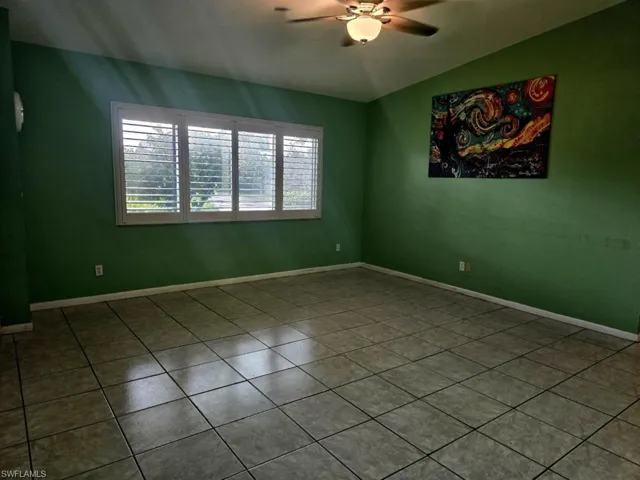 Tiled spare room with ceiling fan