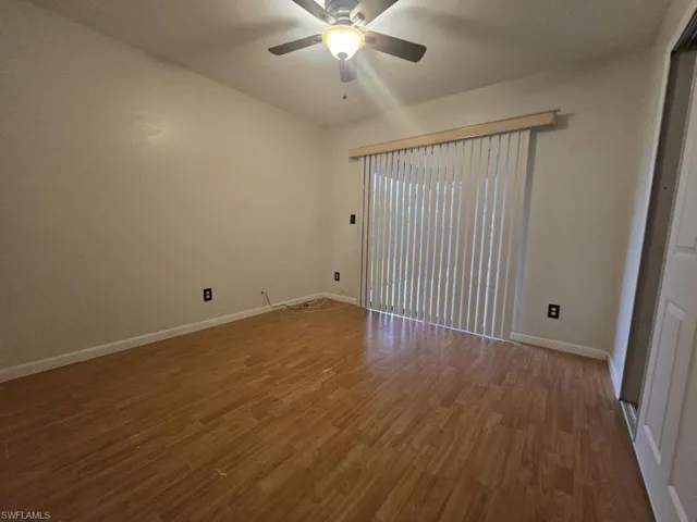 Spare room with ceiling fan and hardwood / wood-style flooring
