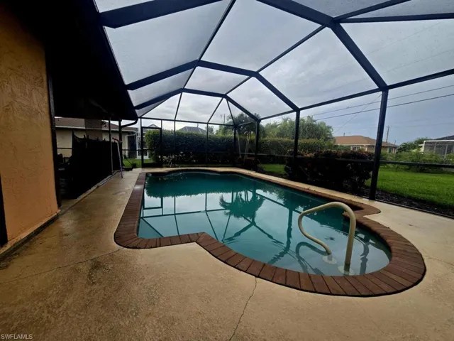View of swimming pool featuring a lanai and a patio area