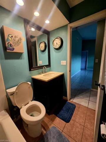 Bathroom featuring vanity, toilet, and tile patterned flooring