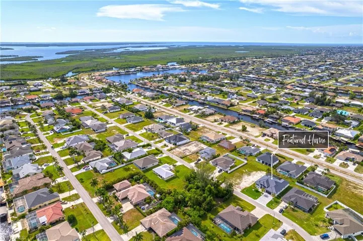 Aerial overview of property's location featuring a large body of water and nearby suburban area