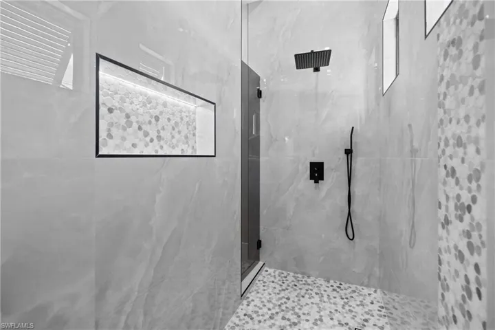 Bathroom featuring a marble finish shower