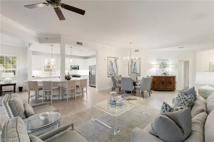 Living area with a chandelier, crown molding, light tile patterned floors, a ceiling fan, and recessed lighting