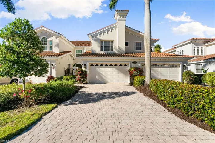 Mediterranean / spanish-style house with decorative driveway, stucco siding, and a tiled roof