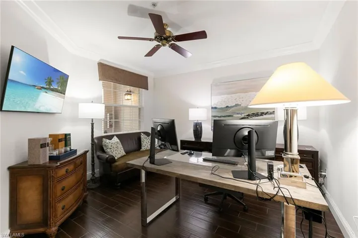 Office space with ornamental molding, wood tiled floors, and a ceiling fan