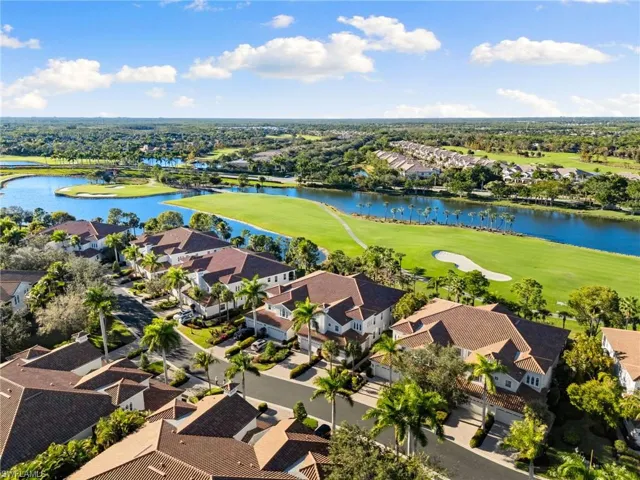Aerial view of residential area with a local golf course and a large body of water