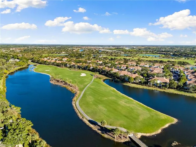 Aerial view of residential area with a local golf course and a large body of water