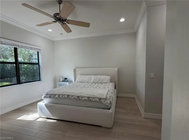 Bedroom featuring light wood finished floors, crown molding, a ceiling fan, and recessed lighting