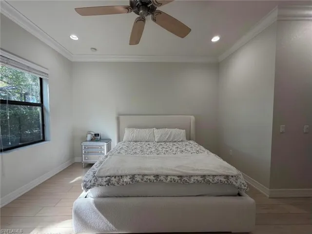 Bedroom featuring crown molding, light wood-type flooring, ceiling fan, and recessed lighting